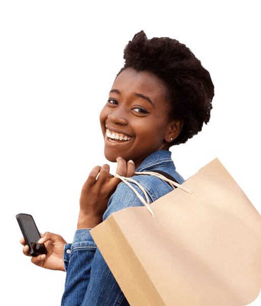 Smiling woman with a grocery bag over her sholder and holding a smartphone