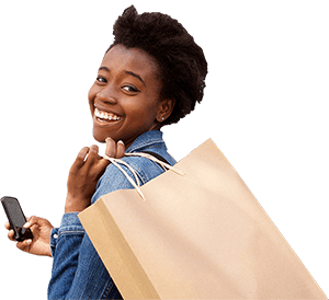 Smiling woman with a grocery bag over her sholder and holding a smartphone