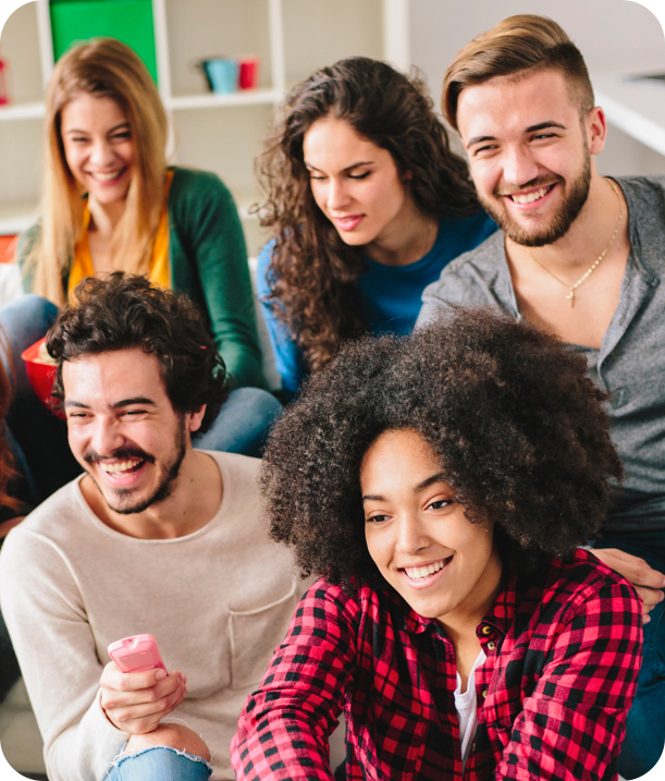 A group of friends watching tv and laughing