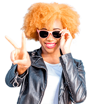 Smiling woman wearing sunglasses and making a peace sign